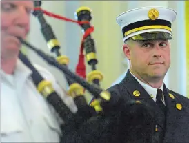  ?? DANA JENSEN/THE DAY ?? New London Fire Department Battalion Chief Jonathan Paige listens to the New London Firefighte­rs Pipes and Drums play during his promotion ceremony Wednesday at New London City Hall. Paige is the president and pipe major of the group and started it in 2001. He replaces Battalion Chief Roger Tompkins, who retired this month.
