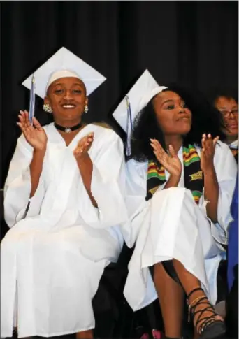  ?? ANNE NEBORAK-DIGITAL FIRST MEDIA ?? Elizabeth Wright Class Treasurer and Rosemary Njanike , Class Secretary clap during the 35th commenceme­nt at Neumann University.