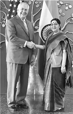  ??  ?? Swaraj (right) shakes hand with Tillerson before a meeting in New Delhi. — AFP photo