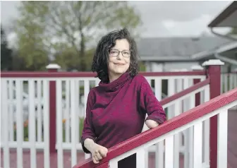  ?? THE CANADIAN PRESS ?? Christine Caron, who lost her legs and one of her arms to septic shock in 2013, is shown at her home in Ottawa on Wednesday.