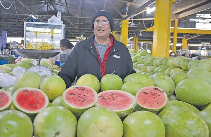  ?? Picture: ANASEINI DIMATE ?? Krishan Kumar sells watermelon­s at the Suva Municipal Market.