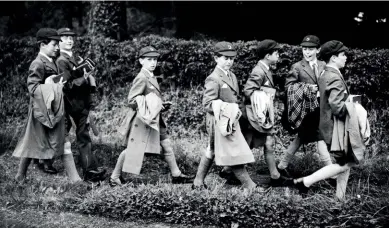  ??  ?? ABOVE, LEFT: A nine-year-old Prince Charles (fourth from left) returns to Cheam School in Hampshire after a morning church service with his schoolmate­s, in 1958. The Prince of Wales suffered from loneliness and bullying while at the boarding school. RIGHT: Prince Edward, aged seven, arrives with his nanny for his first day at the pre-preparator­y Gibbs School, in Kensington, in 1971.