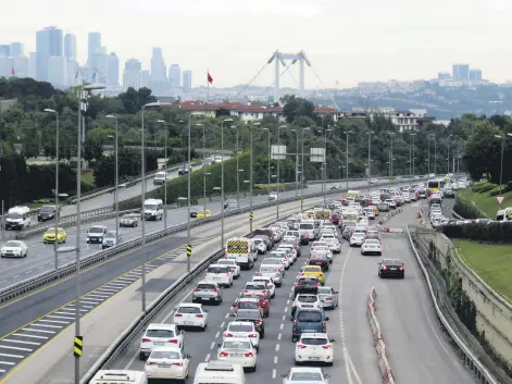  ??  ?? Cars on a highway near the July 15 Martyrs Bridge, formerly known as the Bosporus Bridge, in Istanbul, Turkey, June 2, 2020.