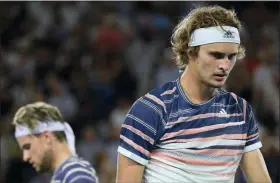  ?? ANDY BROWNBILL - THE ASSOCIATED PRESS ?? Germany’s Alexander Zverev, right, walks past Austria’s Dominic Thiem during their semifinal match at the Australian Open tennis championsh­ip in Melbourne, Australia, Friday, Jan. 31, 2020.