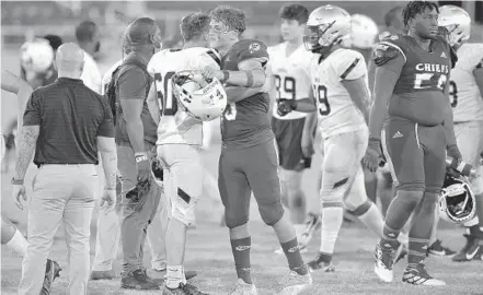  ?? MICHAEL LAUGHLIN/ SOUTH FLORIDA SUN SENTINEL ?? St. Thomas Aquinas’ Zachary Tolerico and Cardinal Gibbons’ Danny Feliciano meet after their game on Oct. 16. Both the Raiders and Chiefs will play for state titles this week.