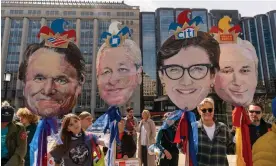  ?? Photograph: Alex Brandon/AP ?? Activists hold likenesses of bank CEOs during a protest in Washington DC on 21 March.