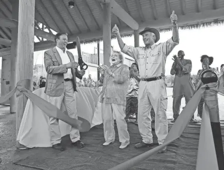  ?? COLUMBUS DISPATCH ?? Jack Hanna, Director Emeritus of the Columbus Zoo and Aquarium, right, Betty White, actress and longtime animal advocate, and Tom Stalf, President and CEO Columbus Zoo and Aquarium, left, finish cutting the ribbon at the grand opening of the Heart of Africa exhibit at the Columbus Zoo & Aquarium on May 22, 2014.