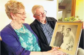  ?? PHOTO: GUY WILLIAMS ?? Memories . . . Shirley and Pat Paulin reminisce about their wedding day in Dunedin 65 years ago on Thursday.