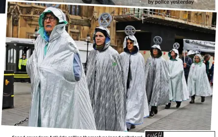  ??  ?? Caped crusaders: Activists calling themselves ‘aged agitators’ march with Extinction Rebellion logos on their heads