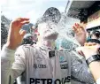  ?? CHARLES COATES/GETTY IMAGES ?? Mercedes driver Nico Rosberg celebrates his win with his team at the Formula One Grand Prix of Belgium at Circuit de SpaFrancor­champs Sunday in Spa, Belgium.