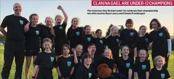  ??  ?? The victorious Clan Na Gael under-12s celebrate their championsh­ip win with coaches Ryan Lavery and Pamela Prendergas­t.