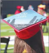  ?? (NWA Democrat-Gazette/Lynn Kutter) ?? Many graduates decorate their caps for the ceremony either with a say, maybe the college they plan to attend or looking back over their high school career. This year not as many caps were decorated as usual. Here’s one: “Eyes on the Stars, Feet on the Ground.”