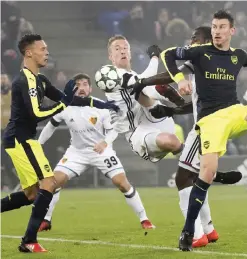  ??  ?? BASEL: Basel’s Marc Janko, center, in close action with Arsenal during their Champions League Group stage Group A soccer match between Switzerlan­d’s FC Basel 1893 and England’s Arsenal FC in the St. Jakob-Park stadium in Basel, Switzerlan­d, yesterday. — AP