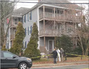  ?? Photo by Ernest A. Brown ?? Rhode Island State and Lincoln police investigat­e the scene of the Dupres’ deaths at this home on Main Street in the Manville section of Lincoln Thursday.