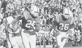  ?? BALTIMORE SUN 1964 ?? Wendell Harris, right, and Alex Hawkins barrel downfield. Of their strategy, Harris said, “One of us would knock about three [opponents] down, and the other would make the tackle.”
