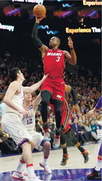  ?? AP FOTO ?? THROWBACK. Dwayne Wade shoots over defender Ersan Ilyasova in Game 2 of the first round playoff series between the Miami Heat and the Philadelph­ia 76ers.