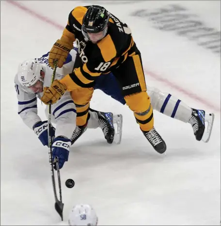  ?? STUART CAHILL — BOSTON HERALD ?? Boston Bruins center Pavel Zacha, right, and Toronto Maple Leafs center John Tavares battle for the puck during a Jan. 14 game at the TD Garden in Boston. Zacha has 12 points in his last 12 games.