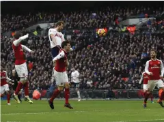  ?? AFP ?? Tottenham’s Harry Kane, second left, heads the ball to score against Arsenal.