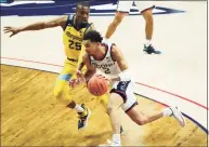  ?? David Butler II / Associated Press ?? UConn guard James Bouknight ( 2) drives to the basket against Marquette guard Koby McEwen ( 25) on Saturday.