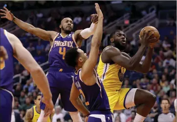  ?? MATT YORK — THE ASSOCIATED PRESS ?? Warriors forward Eric Paschall, right, drives between Phoenix guard Jevon Carter (4) and forward Elie Okobo (2) during the first half of Saturday’s game in Phoenix. Paschall scored 25points.