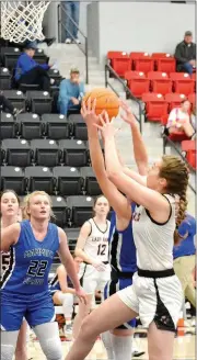  ?? TIMES photograph­s by Annette Beard ?? Junior Lady Blackhawk Sydney Spears, No. 4, reached for the rebound during the championsh­ip game of the Pea Ridge Holiday Tournament Thursday, Dec. 30.