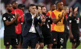  ?? Photograph: Dean Mouhtaropo­ulos/Getty Images ?? John Herdman and his team pay tribute to Canada fans after their loss to Croatia.