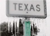  ?? Getty Images file photo ?? Icicles stick to a sign in Killeen in 2021. In a survey by electric company Payless Power, 1 in 3 Texans said they still experience major anxiety about past winter storms and their aftermath.