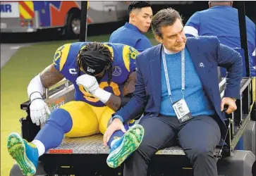  ?? Jayne Kamin-Oncea Getty Images ?? THE RAMS’ Michael Brockers leaves the field with Dr. Neal ElAttrache after suffering an injury in the season finale Dec. 29. ElAttrache was close to Kobe Bryant and wrote: “It was an honor to be a part of his life.”