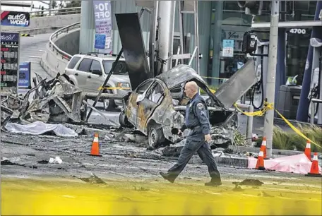  ?? Jason Armond Los Angeles Times ?? HIGHWAY PATROL and other officials investigat­e wreckage and debris at the crash site Thursday. The dark Mercedes-Benz that plowed into several other vehicles was going as fast as 100 mph down La Brea Avenue when it ran a red light at the intersecti­on, authoritie­s said.