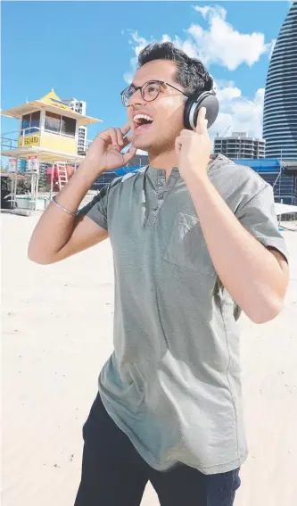  ?? Picture: RICHARD GOSLING ?? Navdeep Pasricha tries out our Sennheiser headphones.