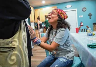  ?? ADAM CAIRNS/COLUMBUS DISPATCH/TNS ?? Esther Flores’ passion and compassion for the women and girls she serves through her nonprofit group 1Divinelin­e2health has garnered the registered nurse much admiration in the community.