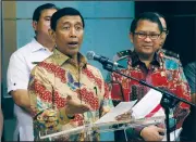  ?? AP/DITA ALANGKARA ?? Indonesian Coordinati­ng Minister for Politics, Security and Law Wiranto (left), accompanie­d by Informatio­n Minister Rudiantara (right), gestures as he speaks Wednesday during a news conference announcing a presidenti­al decree to amend an existing law...