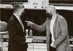  ?? Steph Chambers / Getty Images ?? The Rockets’ Rafael Stone, right, talking with fellow GM Neil Oshey of Portland, says the franchise is pointing in the right direction after the James Harden trade.