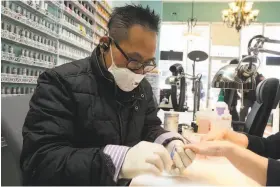  ?? Liz Hafalia / The Chronicle ?? Kevin Le does a customer’s nails at New York Nail salon in the Outer Mission. The salon has stopped using polish that contains the toxic chemical toluene.