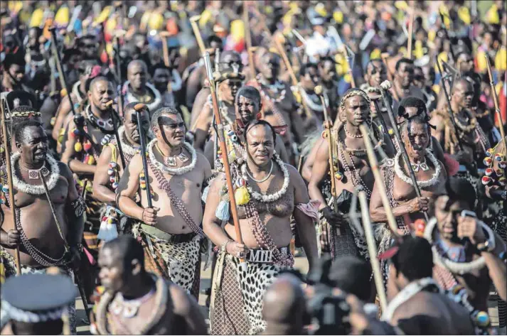  ??  ?? Feudal: In a country controlled by a secretive and powerful monarchy, crossing King Mswati III of Swaziland (centre) could be detrimenta­l.