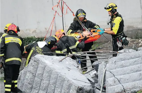  ?? LUCA ZENNARO /ANSA VIA THE ASSOCIATED PRESS ?? A large section of the Morandi bridge in Genoa, Italy, built in the 1960s, collapsed during a fierce storm Tuesday, sending vehicles about 90 metres to the ground below. One truck came within metres of plunging off the bridge. Others weren’t so fortunate, though there were survivors pulled from the rubble.