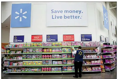  ?? AP ?? Walmart employee Kenneth White scans items during a Walmart Academy class session at the store in North Bergen, N.J. Starting Thursday, Walmart employees will be able to use mobile devices to process some shoppers’ payments, allowing them to bypass long checkout lines.