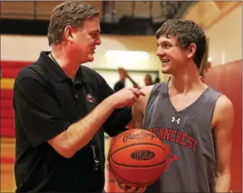  ?? DIGITAL FIRST MEDIA FILE ?? Penncrest basketball coach Mike Doyle, left, talks to his son Mike, a guard on the team who graduated in 2015. The Doyles are one example of father-son sports combinatio­ns that illustrate how sports can help strengthen a family bond.