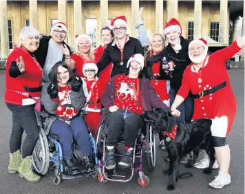  ??  ?? Theas Richards, front left, and Bethan Griffiths, with father and carer, and members of the Divine Girls team, together after taking part in run