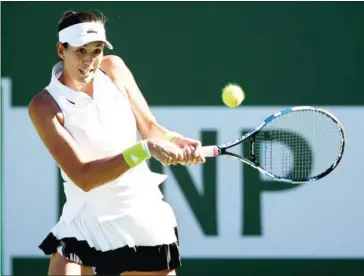  ?? STOCKMAN/GETTY IMAGES/AFP ?? Garbine Muguruza of Spain plays Kayla Day during the BNP Paribas Open at the Indian Wells Tennis Garden on Sunday in California.