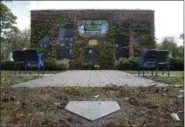  ?? CHARLES REX ARBOGAST — THE ASSOCIATED PRESS ?? A replica of Wrigley Field’s outfield ivy walls, four stadium seats and a home plate called “Beyond The Ivy,” is the final resting place for the ashes of nine Cubs fans at the Bohemian Cemetery Wednesday in Chicago.