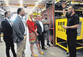  ?? BRENT DAVIS WATERLOO REGION RECORD ?? VeriForm president Paul Rak, right, shows some of the energy-saving initiative­s his company has implemente­d during a tour Wednesday for Environmen­t Minister Catherine McKenna and MPs Marwan Tabbara, Raj Saini and Bryan May.