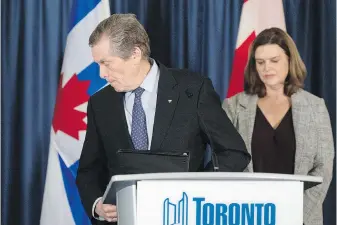  ?? CHRIS YOUNG, THE CANADIAN PRESS ?? John Tory walks away from the Toronto city hall podium on Friday as Deputy Mayor Jennifer McKelvie looks on.