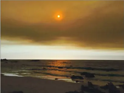  ?? DAVID KELLOGG — MONTEREY HERALD FILE ?? Smoke from record wildfires that blanketed Northern California, including Monterey County, turned skies an otherworld­ly orange, raising health concerns.