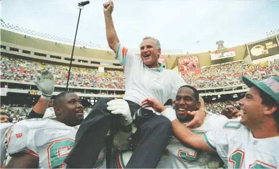  ?? GARY HERSHORN/REUTERS/FILES ?? Dolphins players hoist coach Don Shula after beating the Eagles on Nov. 14, 1993. It was Shula’s 325th career win, making him the NFL’S all-time leader.