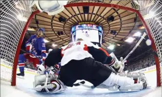  ?? BRUCE BENNETT, GETTY IMAGES ?? The Rangers’ Nick Holden beats Senators goalie Craig Anderson with this first-period goal on Thursday night at Madison Square Garden. Game 5 is Saturday afternoon back in Ottawa, where the Sens won the first two.