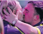  ?? ?? Luke Littler kisses Eloise, his new girlfriend, after his victory over 50-year-old Brendan Dolan