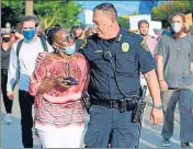  ?? AFP ?? Houston police chief Art Acevedo walks arm-in-arm with a woman during a ‘Justice for George Floyd’ event.