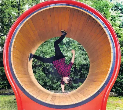  ?? PHOTO: PETER MCINTOSH ?? Roll up, roll up . . . Dunedin North Intermedia­te teacher Craig Beer goes for a spin on the school’s new hamster wheel.