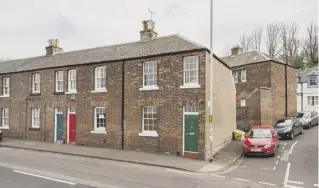  ??  ?? 0 The first-floor drawing room has sea views, sash and case windows, wooden floors and one of the two fireplaces in the house. 0 The front of the endterrace­d property and the kitchen.